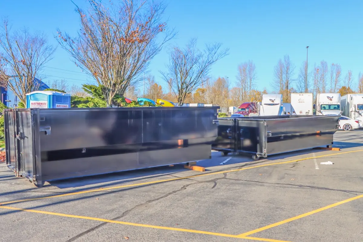 Professional dumpster rental service with roll-off container on residential driveway in Ravenna